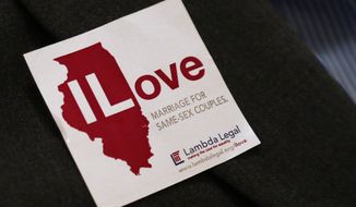 **FILE** A supporter of same sex-marriage wears a sticker on her jacket before attending a state Senate Executive Committee hearing on the topic at the Illinois Capitol in Springfield, Ill., on Jan. 3, 2013. (AP Photo/Seth Perlman)