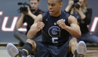Georgetown guard Markel Starks clenches his fists after drawing a charging foul against Cincinnati in the second half of an NCAA college basketball game, Friday, Feb. 15, 2013, in Cincinnati. Starks led Georgetown to a 62-55 win with 17 points. (AP Photo/Al Behrman)
