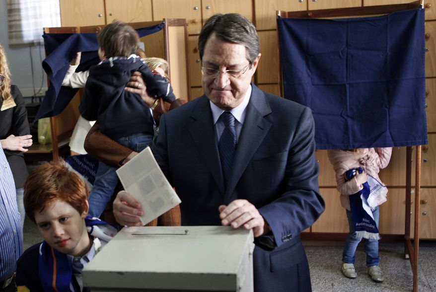 Presidential candidate Nicos Anastasiades votes in Cypriot elections in the southern port city of Limassol, Cyprus, on Sunday, Feb. 17, 2013. Cypriots are voting for a new leader amid a financial crisis in which the country needs a rescue package from international creditors to stave off bankruptcy. (AP Photo/Petros Karadjias)