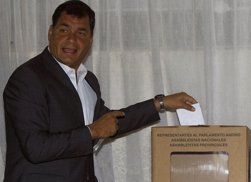 Ecuadorean President Rafael Correa casts his vote for National Assembly members in Quito, Ecuador, on Sunday, Feb. 17, 2013. Voters were electing the president, vice president and National Assembly members, with Mr. Correa highly favored to win a second re-election. His government has won broad backing from the lower classes as it leads Latin America in social spending. (AP Photo/Dolores Ochoa)