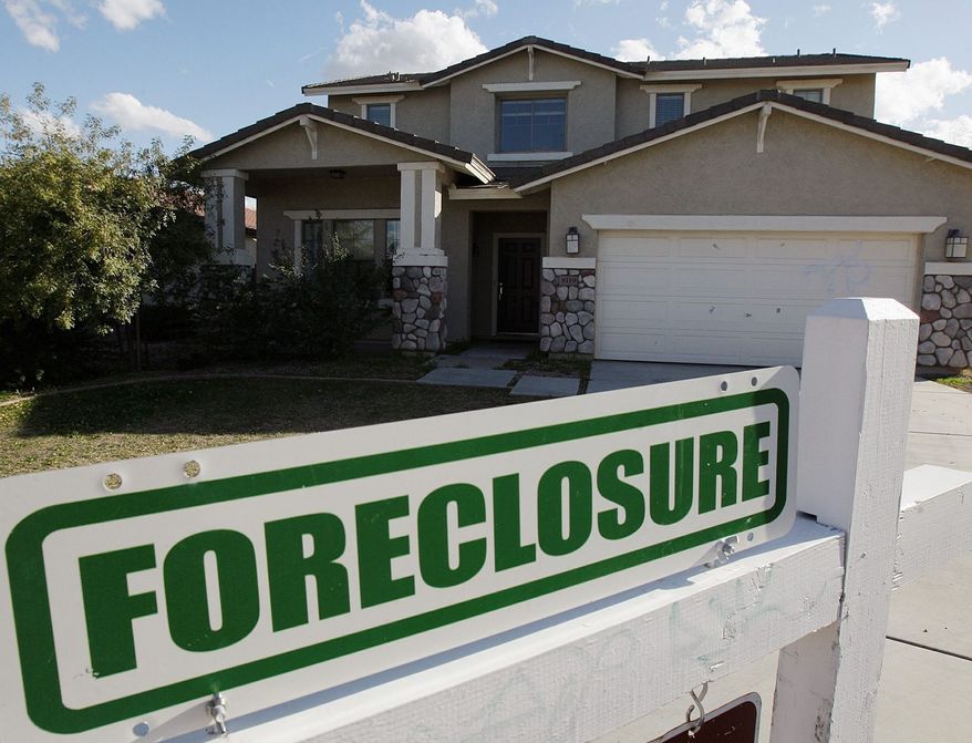 ** FILE ** A foreclosure sign sits outside a home for sale in Phoenix, Tuesday, Feb. 17, 2009. (AP Photo/Ross D. Franklin)