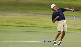 **FILE** President Obama watches the ball after making a putt on the ninth green during his golf match at the Mid-Pacific County Club in Kailua, Hawaii, on Dec. 31, 2009. (Associated Press)