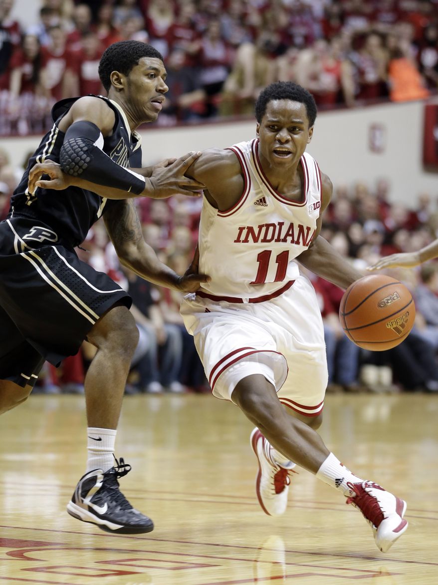 Indiana guard Yogi Ferrell, right, drives on Purdue guard Ronnie Johnson in the second half of a NCAA college basketball game in Bloomington, Ind., Saturday, Feb. 16, 2013. Indiana defeated Purdue 83-55. (AP Photo/Michael Conroy)