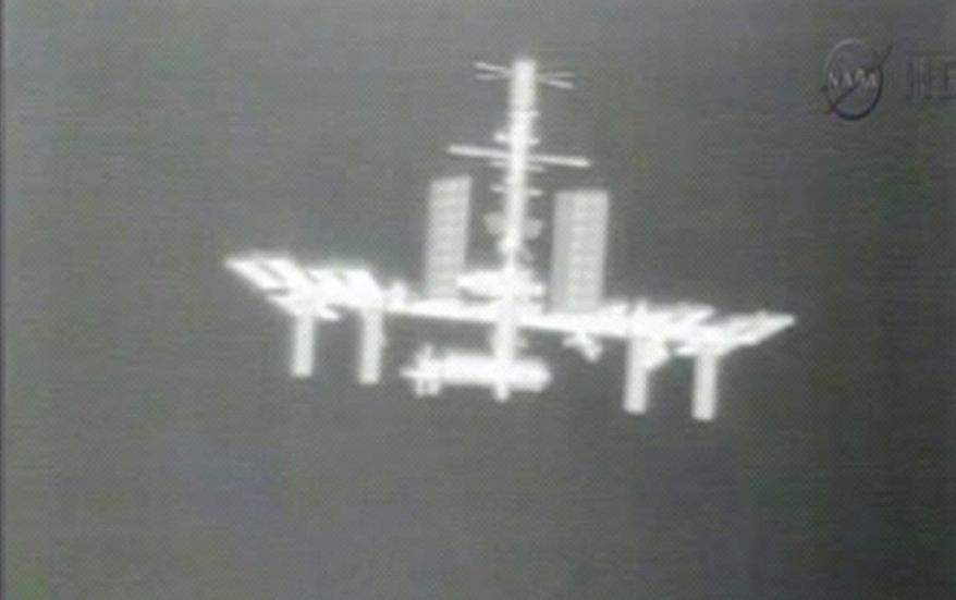 ** FILE ** The International Space Station is photographed by a thermal imaging camera aboard the SpaceX Dragon commercial cargo craft as it approaches the station on Thursday, May 24, 2012. (AP Photo/NASA)