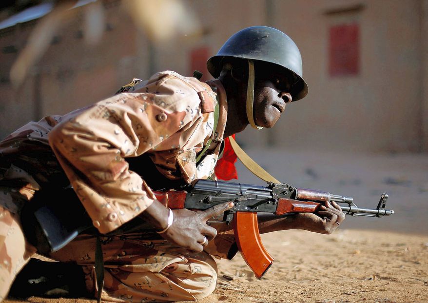 associated press
A Malian soldier takes cover during exchanges of gunfire with jihadists in Gao, a key city recently reclaimed with the help of the French army from the grip of Islamic extremists.