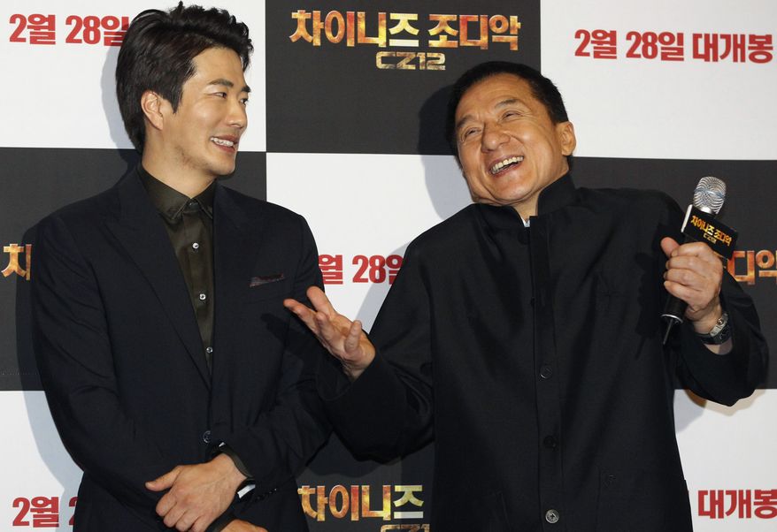 Hong Kong actor-director Jackie Chan (right) and South Korean actor Kwon Sang-woo promote their latest movie, "CZ12," or "Chinese Zodiac," in Seoul on Monday, Feb. 18, 2013. (AP Photo/Ahn Young-joon)