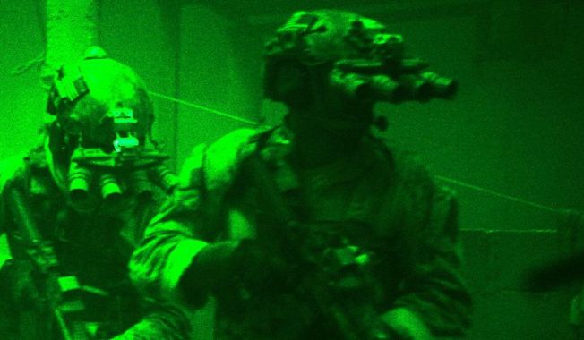 This undated publicity photo released by Columbia Pictures Industries, Inc. shows Navy SEALs seen through the greenish glow of night vision goggles, as they prepare to breach a locked door in Osama Bin Laden&#x27;s compound in Columbia Pictures&#x27; hyper-realistic new action thriller from director Kathryn Bigelow, &quot;Zero Dark Thirty.&quot; (AP Photo/Columbia Pictures Industries, Inc., Jonathan Olley)