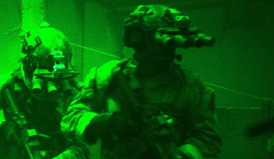 This undated publicity photo released by Columbia Pictures Industries, Inc. shows Navy SEALs seen through the greenish glow of night vision goggles, as they prepare to breach a locked door in Osama Bin Laden&#39;s compound in Columbia Pictures&#39; hyper-realistic new action thriller from director Kathryn Bigelow, &quot;Zero Dark Thirty.&quot; (AP Photo/Columbia Pictures Industries, Inc., Jonathan Olley)