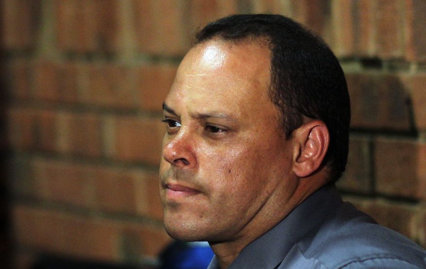 ** FILE ** In this Wednesday, Feb. 20, 2013, file photo, investigating officer Hilton Botha, sits inside the court witness box during the Oscar Pistorius bail hearing at the magistrate court in Pretoria, South Africa. The lead investigator in the murder case against Oscar Pistorius faces attempted murder charges himself over a 2011 shooting, police said Thursday, Feb. 21, 2013, in another potentially damaging blow to the prosecution. (AP Photo/Themba Hadebe, File)