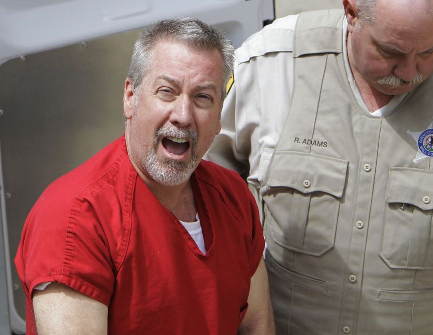 ** FILE ** In this May 8, 2009, file photo, former Bolingbrook, Ill., police sergeant Drew Peterson arrives at the Will County Courthouse in Joliet, Ill., for his arraignment on charges of first-degree murder in the 2004 death of his third wife Kathleen Savio. On Thursday, Feb. 21, 2013, Will County Judge Edward Burmila sentenced Peterson to 38 years in prison for Savio's murder. (AP Photo/M. Spencer Green, File)