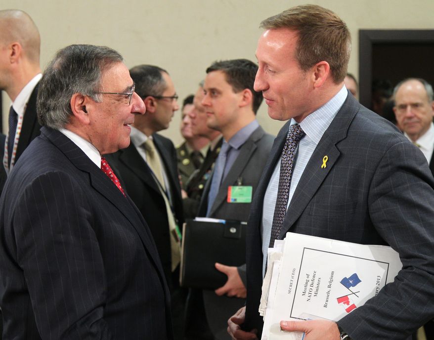 Canada's national defense minister Peter Gordon MacKay, right, talks with U.S. Secretary of Defense Leon Panetta, at the start of a two-day NATO defense ministers meeting to discuss Syria and Afghanistan, at NATO headquarters in Brussels, Thursday, Feb. 21, 2013. (AP Photo/Yves Logghe)