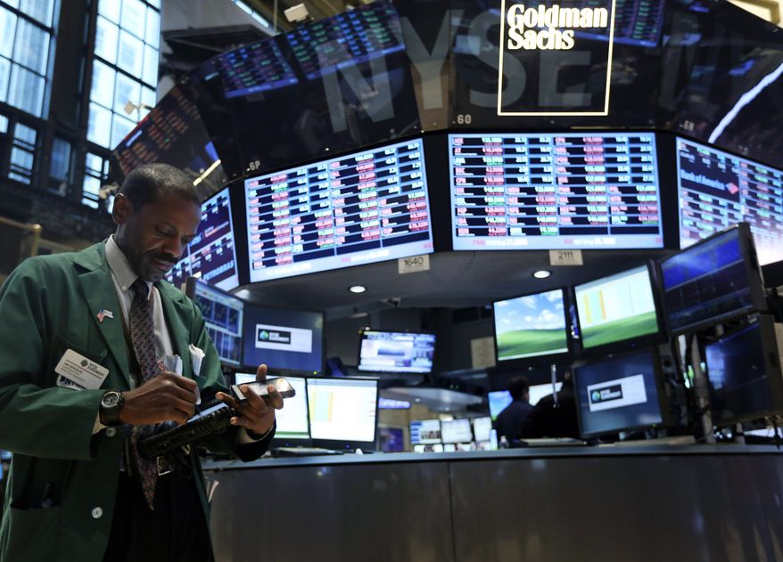 **FILE** A trader works Feb. 21, 2013, on the floor of the New York Stock Exchange. (Associated Press)