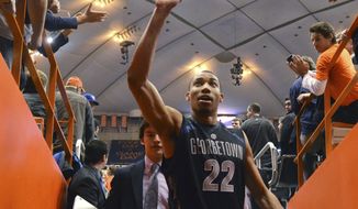 Georgetown&#39;s Otto Porter high-fives fans as he exits the court after his team defeated Syracuse 57-46 in an NCAA college basketball game in Syracuse, N.Y., Saturday, Feb. 23, 2013. (AP Photo/Kevin Rivoli)