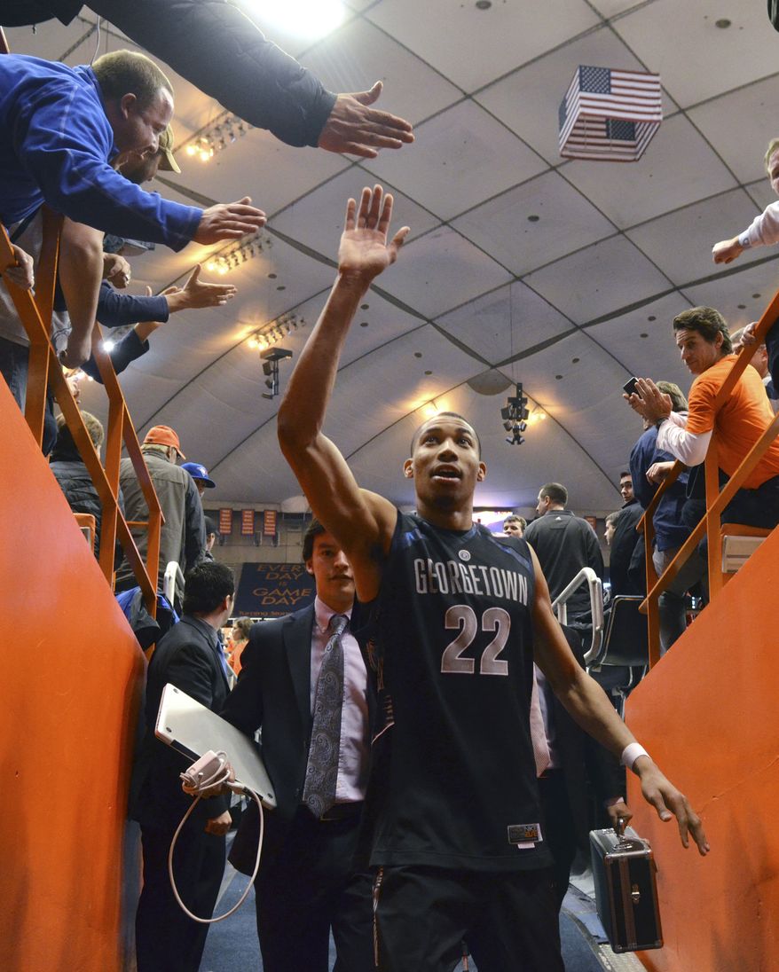 Georgetown&#x27;s Otto Porter high-fives fans as he exits the court after his team defeated Syracuse 57-46 in an NCAA college basketball game in Syracuse, N.Y., Saturday, Feb. 23, 2013. (AP Photo/Kevin Rivoli)