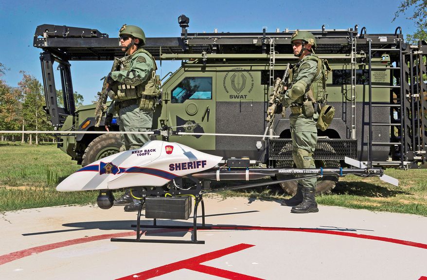 SWAT team members are posted next to a ShadowHawk drone in Texas. Worried about violations of civil liberties, at least 19 states are considering limits on how the unmanned craft can be used. (Vanguard Defense Industries via Associated Press)