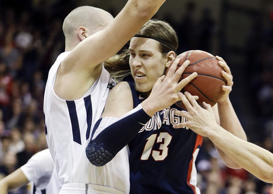 Gonzaga forward Kelly Olynyk has his path blocked by San Diego&#x27;s Dennis Kramer while driving the lane during the first half of an NCAA college basketball game on Saturday Feb. 2, 2013, in San Diego. (AP Photo/Lenny Ignelzi)