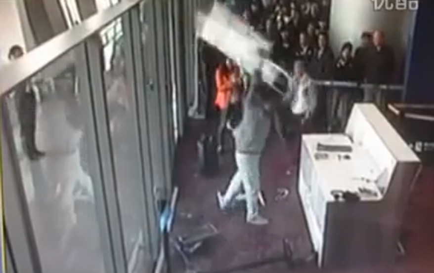 (Screenshot of video from http://hotair.com/archives/2013/02/25/woah-chinese-communist-party-official-goes-berserk-after-he-misses-his-flight/)