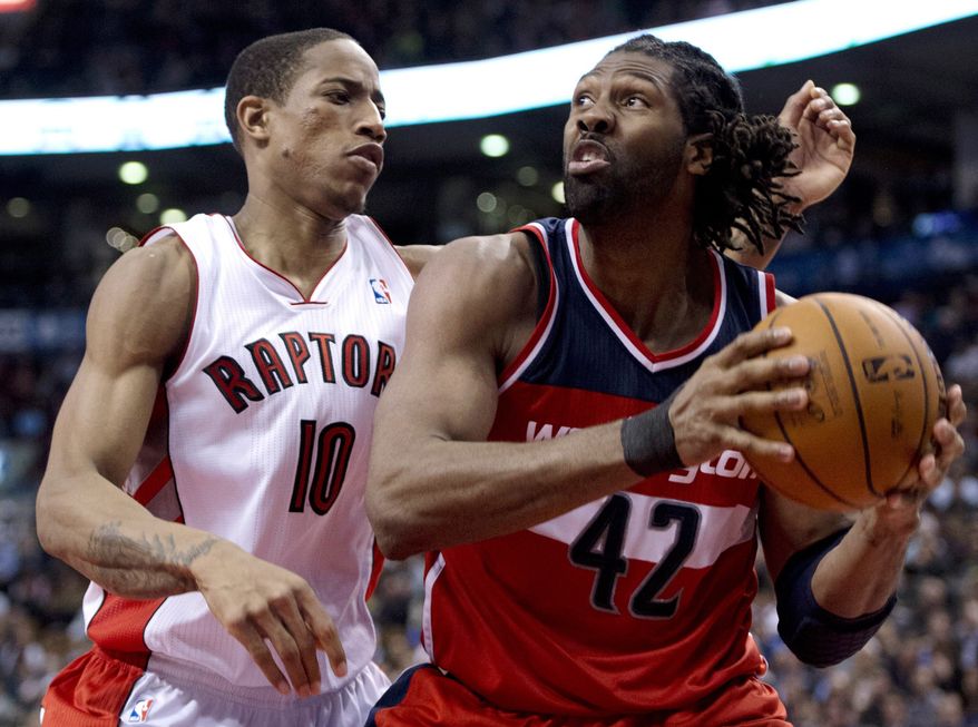 Toronto Raptors guard DeMar DeRozan (10) defends against Washinton Wizards center Nene (42) during the second half of their NBA basketball game, Monday, Feb. 25, 2013, in Toronto. The Wizards won 90-84. (AP Photo/The Canadian Press, Frank Gunn)