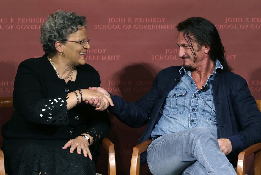 Actor-director Sean Penn (right) shakes hands with Michele Pierre-Louis, the former Haitian prime minister, after they participated in a discussion at Harvard University's Kennedy School of Government in Cambridge, Mass., on Tuesday, Feb. 26, 2013, regarding Haiti in the wake of a devastating earthquake three years ago. Mr. Penn is the co-founder of the J/P Haitian Relief Organization. (AP Photo/Elise Amendola)