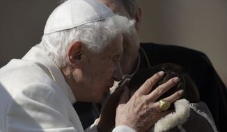 Pope Benedict XVI kisses a baby during his general audience in St. Peter&#39;s Square at the Vatican, Wednesday, Feb. 27, 2013. Pope Benedict XVI basked in an emotional sendoff Wednesday at his final general audience in St. Peter&#39;s Square, recalling moments of &quot;joy and light&quot; during his papacy but also times of great difficulty. (AP Photo/Gregorio Borgia)