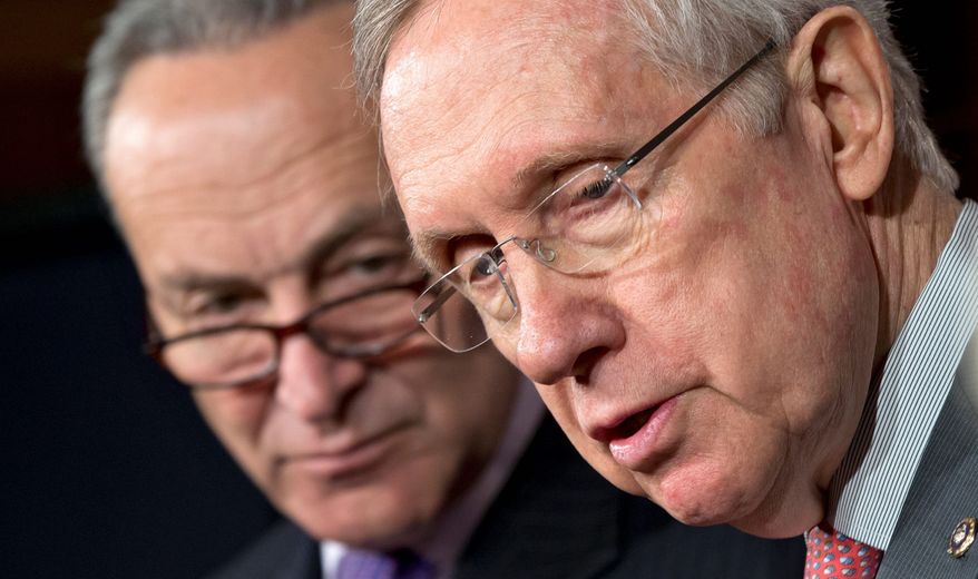 Senate Majority Leader Harry Reid of Nevada (right) and Sen. Charles E. Schumer, New York Democrat, face reporters Thursday on Capitol Hill to talk about the automatic government spending cuts that take effect Friday. (Associated Press)