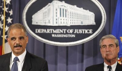 Attorney General Eric H. Holder Jr. (left), accompanied by FBI Director Robert S. Mueller III, announces on Tuesday, Oct. 11, 2011, in Washington that two men have been charged in an alleged plot directed by elements of the Iranian government to murder the Saudi ambassador to the United States. (AP Photo/Haraz N. Ghanbari)