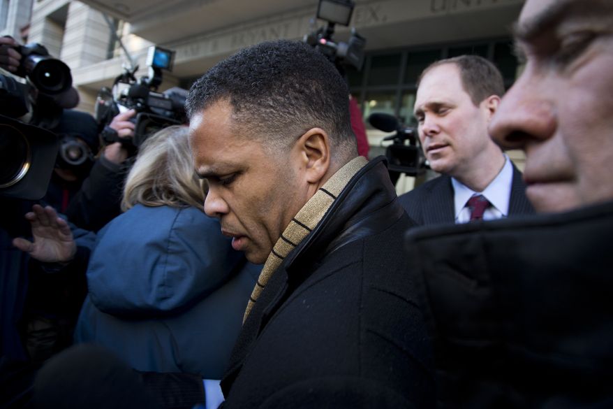 ** FILE ** Former Illinois Rep. Rep. Jesse Jackson Jr. is surrounded as he walks to his car outside the E. Barrett Prettyman Federal Courthouse in Washington, Wednesday, Feb. 20, 2013, after he entered a guilty plea to criminal charges that he engaged in a scheme to spend $750,000 in campaign funds on personal items. (AP Photo/Evan Vucci)