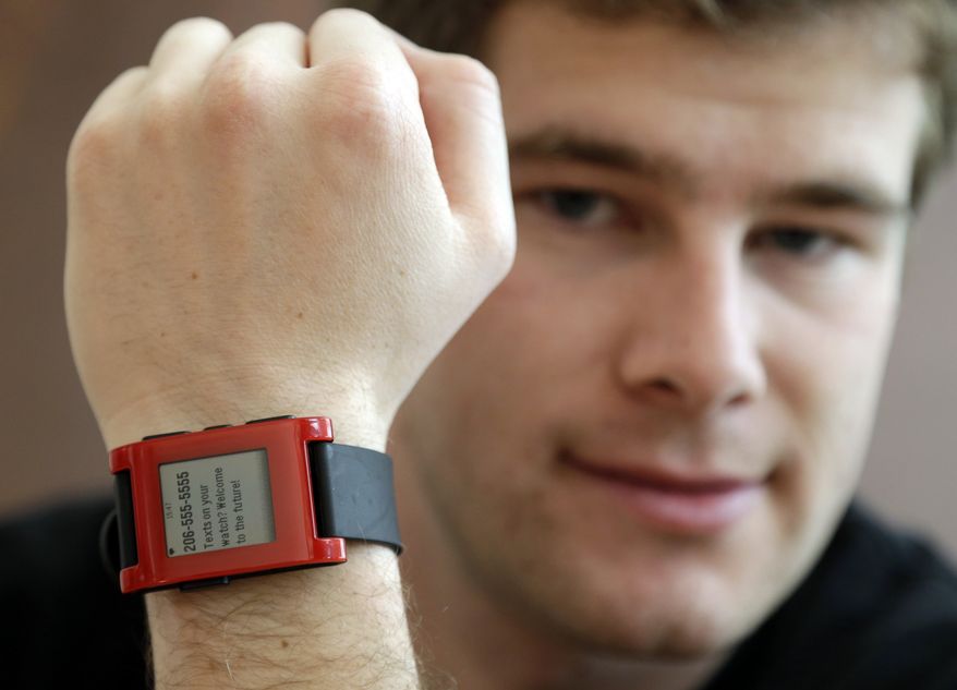 Eric Migicovsky, CEO of Pebble, displays his company's smart watch in Palo Alto, Calif., Tuesday, Feb. 12, 2013. This new watch not only tells time, but also connects to smart phones within 10 meters. (AP Photo/Marcio Jose Sanchez)