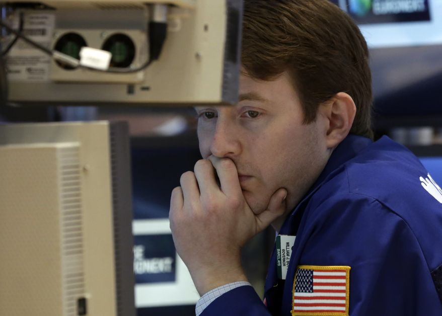 Specialist Peter Elkins works on the floor of the New York Stock Exchange on March 1, 2013. (Associated Press)