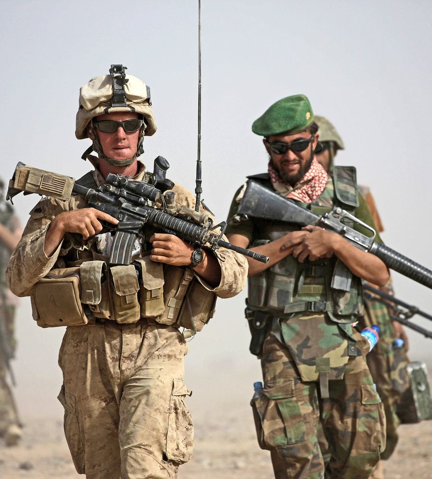 ** FILE ** NATO forces walk together on patrol in this undated photo. (Associated Press)