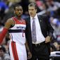 Washington Wizards head coach Randy Wittman, right, speaks with guard John Wall (2) during the second half of an NBA basketball game against the Philadelphia 76ers, Sunday, March 3, 2013, in Washington. The Wizards won 90-87. (AP Photo/Nick Wass)