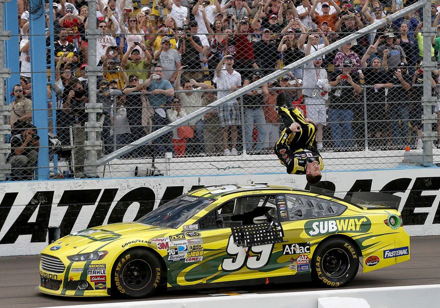 Carl Edwards celebrates winning the NASCAR Sprint Cup Series auto race, Sunday, March 3, 2013, in Avondale, Ariz. (AP Photo/Matt York)
