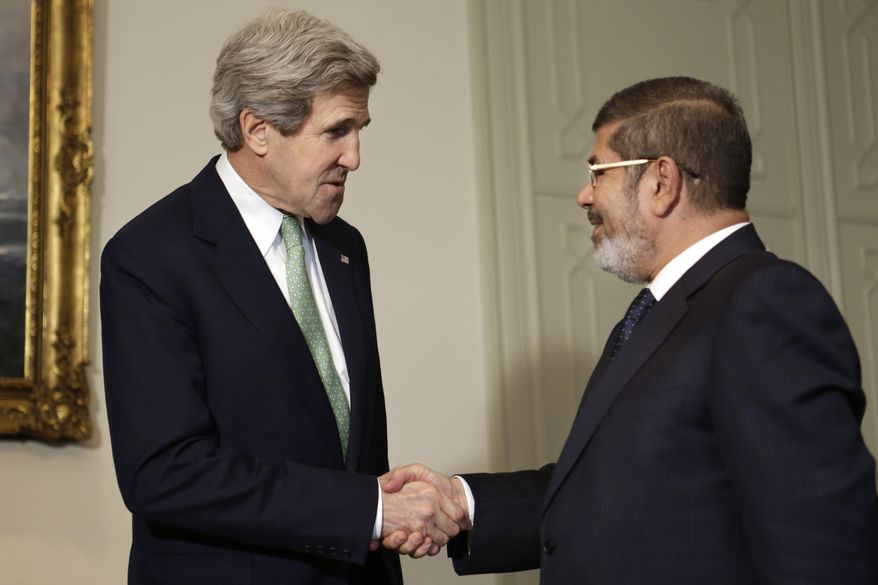 U.S. Secretary of State John F. Kerry (left) shakes hands with Egyptian President Mohammed Morsi at the Presidential Palace in Cairo on Sunday, March 3, 2013. Mr. Kerry is wrapping up a visit to the deeply divided country with an appeal for unity and reform. The United States is deeply concerned that continued instability in Egypt will have broader consequences in a region already rocked by unrest. (AP Photo/Jacquelyn Martin, Pool)