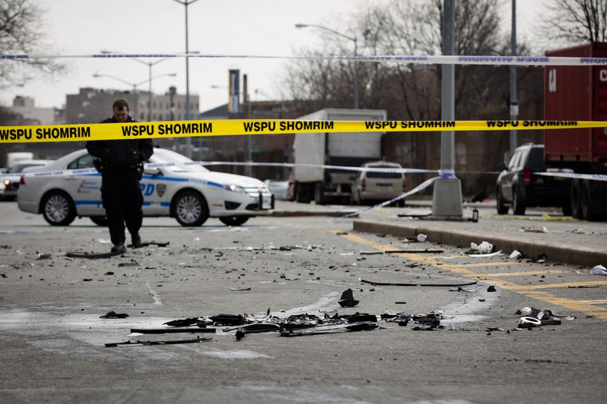 Debris from an auto accident that claimed the lives of two expectant parents litter Kent Avenue on Sunday, March 3, 2013, in the Brooklyn borough of New York. Their baby, who was born prematurely, survived and is in serious condition. (AP Photo/John Minchillo)