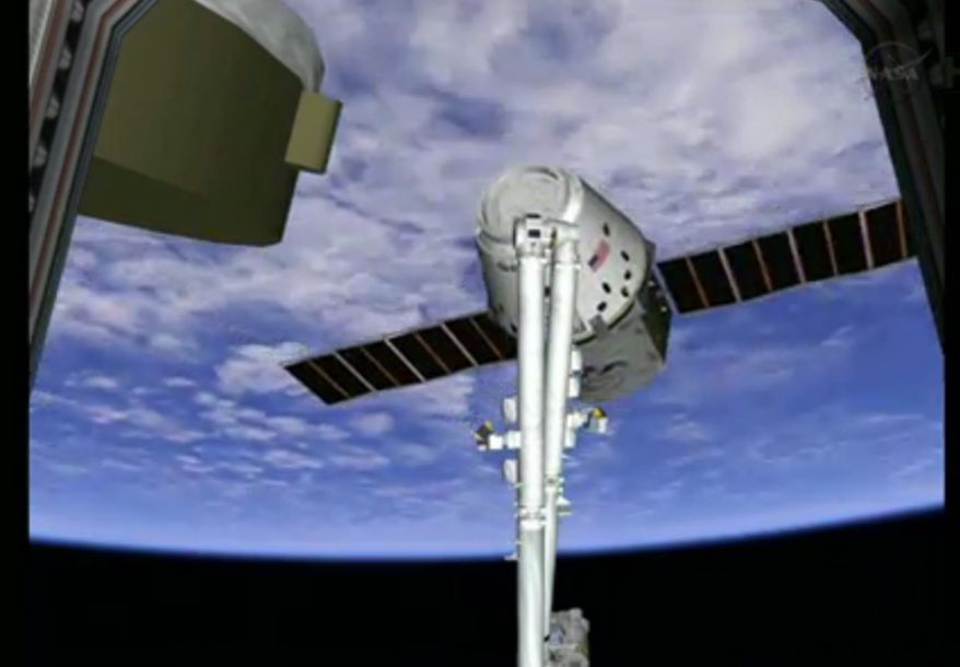 SpaceX Dragon capsule is shown on the end of the International Space Station's robotic arm on Sunday, March 3, 2013. SpaceX, the California-based company founded by billionaire Elon Musk, had to struggle with the Dragon following its launch Friday from Cape Canaveral. The spacecraft is delivering more than 1 ton of supplies to the the space station. (AP Photo/NASA TV)