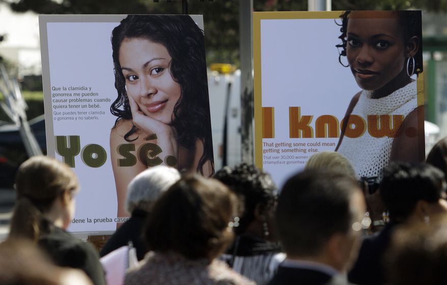 ** FILE ** Public service posters in English and Spanish are seen at a news conference to announce a Los Angeles County program to provide young women in South Los Angeles with home-testing kits for sexually transmitted diseases, at a news conference in the Watts-Willowbrook area of Los Angeles on Sept. 19, 2011. Los Angeles County has the highest number of chlamydia cases and the second-highest number of gonorrhea cases in the country. (Associated Press)