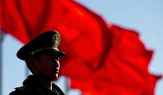 A Chinese paramilitary policeman stands guard on Tiananmen Square while sessions of the National People&#x27;s Congress and the Chinese People&#x27;s Political Consultative Conference are held at the Great Hall of the People in Beijing Monday, March 4, 2013. (AP Photo/Andy Wong)

