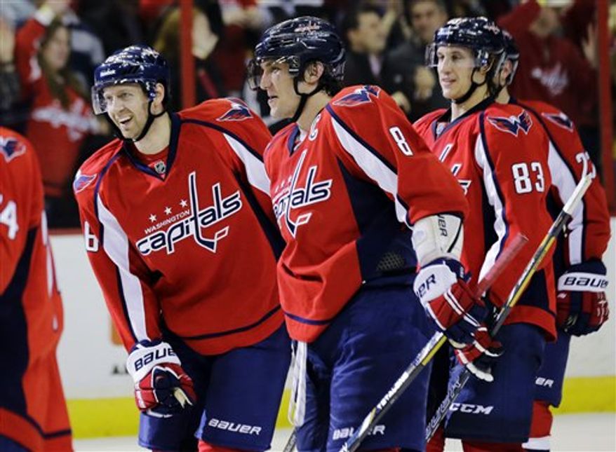 Washington Capitals right wing Eric Fehr (16) celebrates with left wing Alex Ovechkin (8), of Russia, forward Jay Beagle (83) and others after an NHL hockey game against the Boston Bruins, Tuesday, March 5, 2013, in Washington. Fehr scored the winning goal for their 4-3 overtime victory. (AP Photo/Alex Brandon)