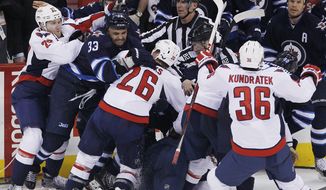 Winnipeg Jets and Washington Capitals mix it up after a play during third-period NHL hockey game action in Winnipeg, Manitoba, Saturday, March 2, 2013. (AP Photo/The Canadian Press, John Woods)