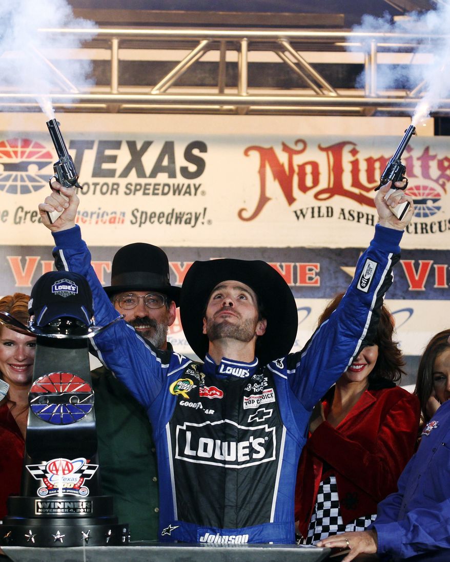 ** FILE ** In this Nov. 4, 2012, file photo, Jimmie Johnson fires blanks out of a pair of revolvers as he celebrates his win in Victory Lane following the NASCAR Sprint Cup Series auto race at Texas Motor Speedway, in Fort Worth, Texas. The National Rifle Association is taking its relationship with racing to a new level as the title sponsor of a NASCAR Sprint Cup Series race. (AP Photo/Tim Sharp, File)