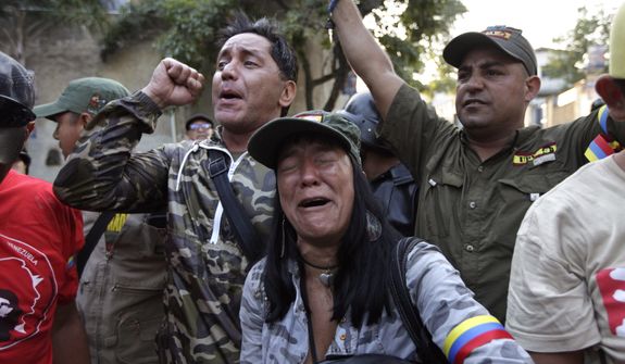 Supporters of Venezuela&#39;s President Hugo Chavez react as they learn that Chavez has died through an announcement by the vice president in Caracas, Venezuela, Tuesday, March 5, 2013. Venezuela&#39;s Vice President Nicolas Maduro announced that Chavez died on Tuesday at age 58 after a nearly two-year bout with cancer. During more than 14 years in office, Chavez routinely challenged the status quo at home and internationally. He polarized Venezuelans with his confrontational and domineering style, yet was also a masterful communicator and strategist who tapped into Venezuelan nationalism to win broad support, particularly among the poor. (AP Photo/Ariana Cubillos)