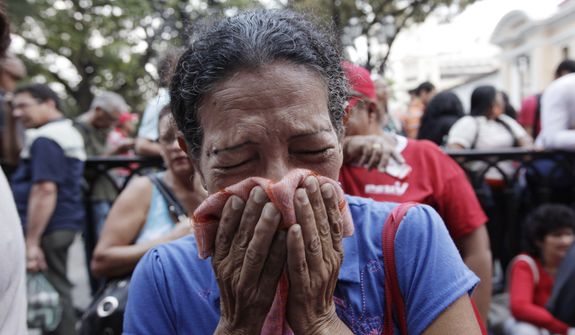 A supporter of Venezuela&#39;s President Hugo Chavez cries as she learns that Chavez has died through an announcement by the vice president in Caracas, Venezuela, Tuesday, March 5, 2013. Venezuela&#39;s Vice President Nicolas Maduro announced that Chavez died on Tuesday at age 58 after a nearly two-year bout with cancer. During more than 14 years in office, Chavez routinely challenged the status quo at home and internationally. He polarized Venezuelans with his confrontational and domineering style, yet was also a masterful communicator and strategist who tapped into Venezuelan nationalism to win broad support, particularly among the poor. (AP Photo/Ariana Cubillos)
