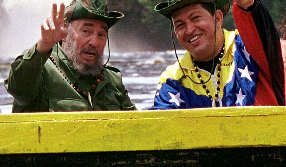 FILE - In this Aug. 12, 2001 file photo released by Miraflores Press Office, Cuba&#39;s President Fidel Castro, left, and Venezuela&#39;s President Hugo Chavez wave to a crowd while touring Canaima National Park in eastern Venezuela in a canoe. Venezuela&#39;s Vice President Nicolas Maduro announced on Tuesday, March 5, 2013 that Chavez has died at age 58 after a nearly two-year bout with cancer. (AP Photo/HO, Miraflores Presidential Palace, Egilda Gomez, File)