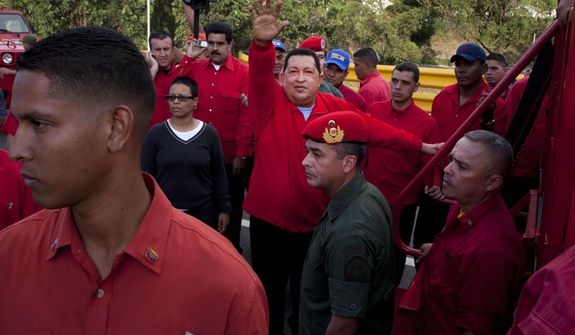 FILE - In this Aug. 3, 2012 file photo, Venezuela&#39;s President Hugo Chavez waves to supporters as he campaigns in the Antimano neighborhood of Caracas, Venezuela. Venezuela&#39;s Vice President Nicolas Maduro announced on Tuesday, March 5, 2013 that Chavez has died at age 58 after a nearly two-year bout with cancer. (AP Photo/Ariana Cubillos, File)