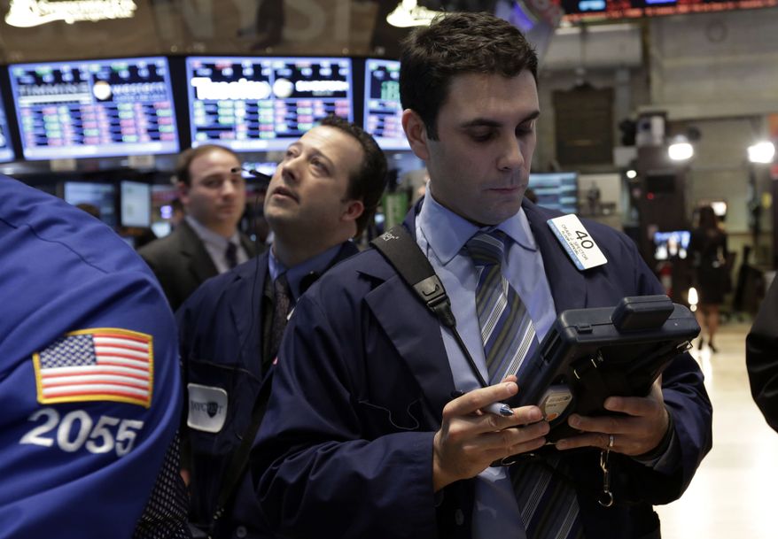 ** FILE ** Trader Craig Spector (right) works on the floor of the New York Stock Exchange on Monday, Feb. 25, 2013, in New York. (AP Photo/Richard Drew)