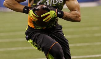 Louisiana State defensive back Tyrann Mathieu runs a drill during the NFL football scouting combine in Indianapolis, Tuesday, Feb. 26, 2013. (AP Photo/Dave Martin)