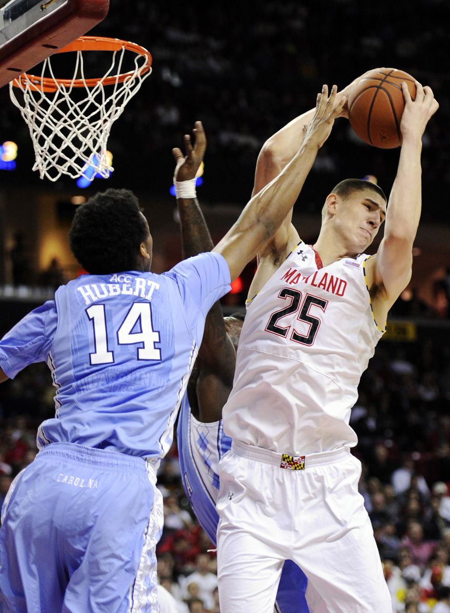 Maryland center Alex Len (25) grabs a rebound against North Carolina forward Desmond Hubert (14) during the first half of an NCAA college basketball game, Wednesday, March 6, 2013, in College Park, Md. (AP Photo/Nick Wass)