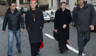 Cardinals Jean-Baptiste Pham Minh Man (second from left) of Vietnam and Cardinal Giuseppe Betori (second from right) of Italy are escorted to a meeting of fellow prelates at the Vatican on Thursday, March 7, 2013. Cardinal Man was the last of the 115 voting-age cardinals to arrive in Rome for the pre-conclave meetings. (AP Photo/Andrew Medichini)