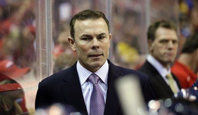 Washington Capitals head coach Adam Oates stands in the bench in the third period of an NHL hockey game against the Boston Bruins Tuesday, March 5, 2013 in Washington. The Capitals won 4-3 in overtime. (AP Photo/Alex Brandon)