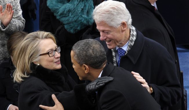 **FILE** President Obama is greeted by then-Secretary of State Hillary Rodham Clinton and former President Bill Clinton for his ceremonial swearing-in on Capitol Hill in Washington on Jan. 21, 2013, during the 57th Presidential Inauguration. (Associated Press)